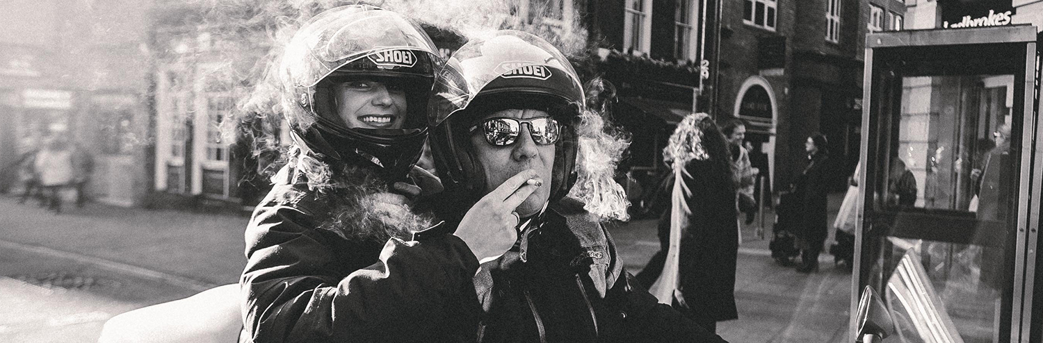 Man-And-Woman-Smoking-On-Motorbike